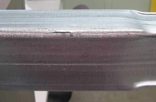 Steel tube with weakened seam weld